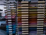 many stacks of books on a metal rack in a room