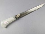 an image of a knife on a table with a tag on it