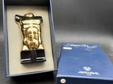 a gold statue of jesus in a box on a table