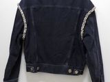 the back of a jacket hanging on a hanger on a wall