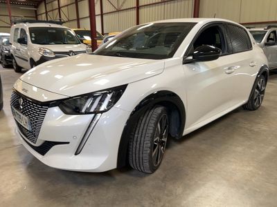 a white car parked in a garage with other cars in the background
