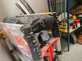 a pile of skis and ski poles in a garage