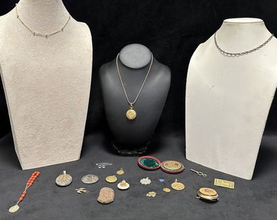 three mannequins with necklaces and other jewelry on a table