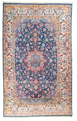 a blue and red rug with a floral design on a white background