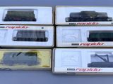 six boxed boxed boxed model trains in boxes on a table