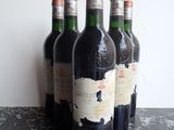 several bottles of wine are lined up on a table