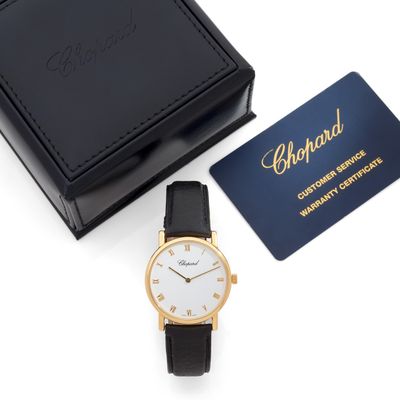 a black and gold watch with a white face and black leather strap