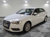 the white audi is parked in a large room with a checkered floor
