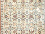 a rug with an orange border and a floral design on it