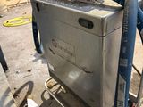 a machine that is sitting on a cart with a hose