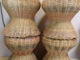 two wicker stools are stacked on top of each other on a wooden table