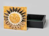 a small box that has a sun design on it