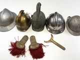 several different types of helmets and a pair of scissors on a white surface