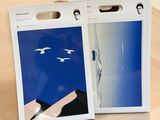 packaging of a pair of white and blue bags on a wooden table