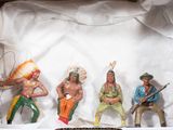 five figurines of native americans in a cardboard box