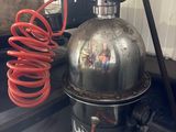 an image of a proprigerator with a hose attached to it