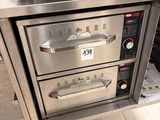 two ovens that are sitting in a kitchen