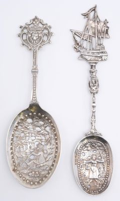 three silver spoons with a ship and a ship on them