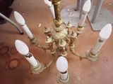 a gold chandelier with white candles on it