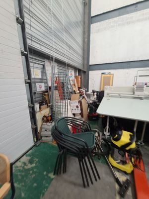 a room with a table, chairs, and other items in it