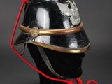 an old helmet with a red cord attached to it