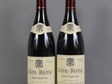 two bottles of wine sitting on top of a table