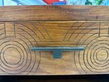 a wooden box that has a design on it