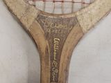 a close up of a tennis racket on a white surface