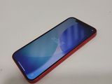 a close up of a red and blue phone on a table