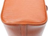 a close up of an orange louis vuitton bag on a white background