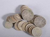 a pile of coins sitting on top of a white table