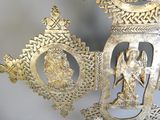 two gold ornaments that are on display on a table
