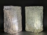 two glass vases that are sitting on a table