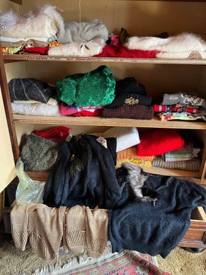 a closet full of clothes and other items in it
