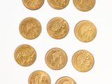 several gold coins are arranged in a circle on a white surface