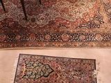 two pictures of a living room with a rug on the floor