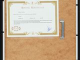 a black frame holds a certificate and a clipboard