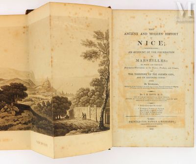 an open book with a picture of a village in the background