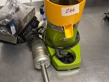a yellow bucket sitting on top of a green machine