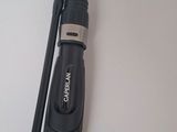 a black and silver fishing rod on a white table