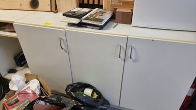 a white refrigerator sitting in a kitchen next to a cabinet
