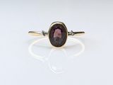 an image of a ring with a purple stone on it