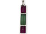 a close up of a silver pendant with a green and red stone