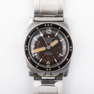 an image of a watch with a brown dial on a silver bracelet