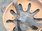 a close up of a metal object with a strap on it