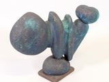 a sculpture of a rock on a stand with a white background