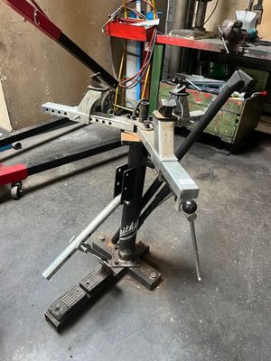 a picture of a man working on a machine in a garage