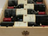 bottles of red wine in a wooden box on a table