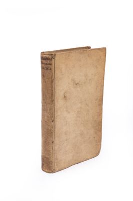 an old book sitting on top of a table next to a white background