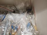 a box full of toothbrushes that are wrapped in plastic